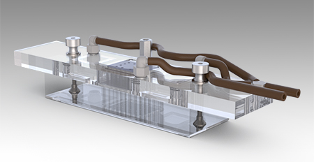 An assembly of a glass slide, a clear rubber block with thru channels, a clear polycarbonate plate with manifold channels and plastic fittings, and rubber vacuum hoses attached to the plastic fittings.