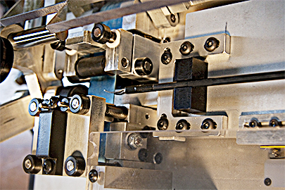A detail of the scissor testing mechanism, showing portions of the feed and tensioning mechanism.