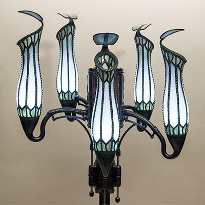 The head of the pitcher plant lamp. Five stained glass shades in the shape of pitcher plants, illuminated from within.